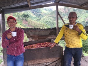 Wilmar and Edier Guarnizo drinking and discussing the latter's coffee on his farm