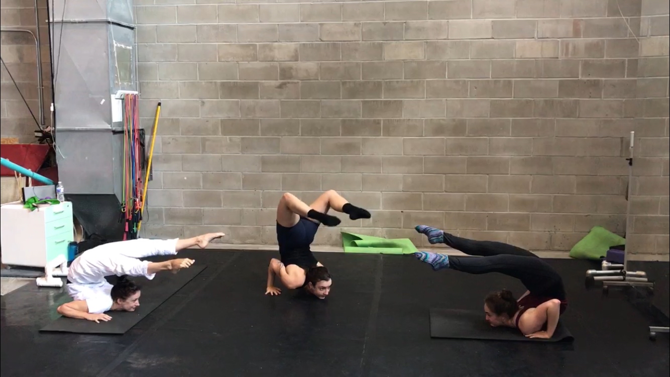 three people stretching