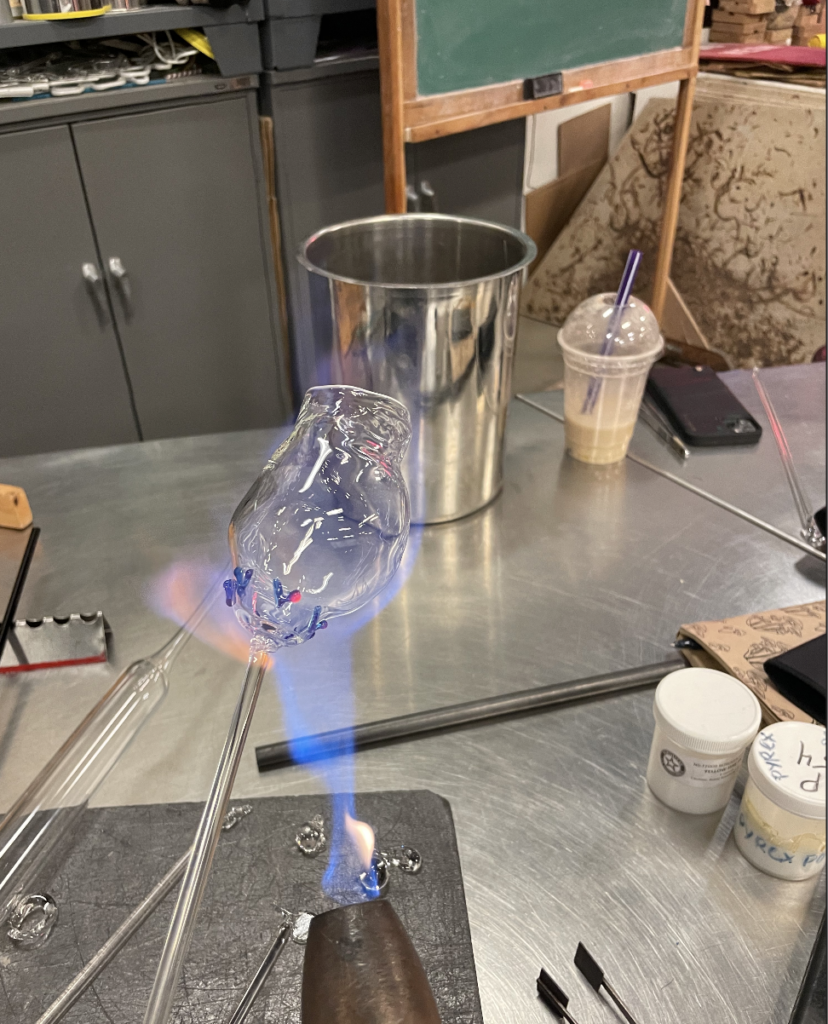 A borosilicate cup annealing in a blue flame