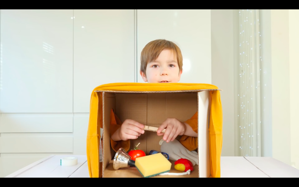 A parent-child game similar to the puzzle box set up in the experiment from YouTube channel The Dad Lab.  