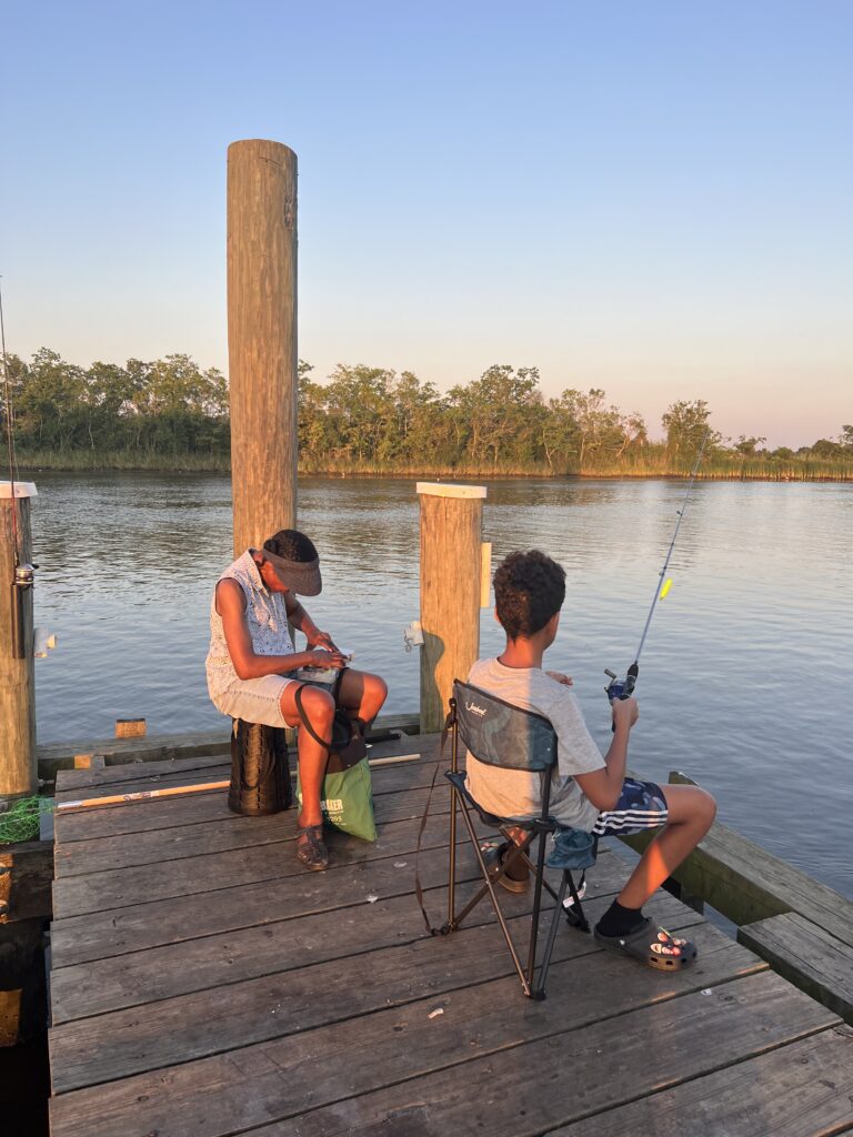 Aunt Marcie and Cousin Maxton preparing their rods for fishing. 
